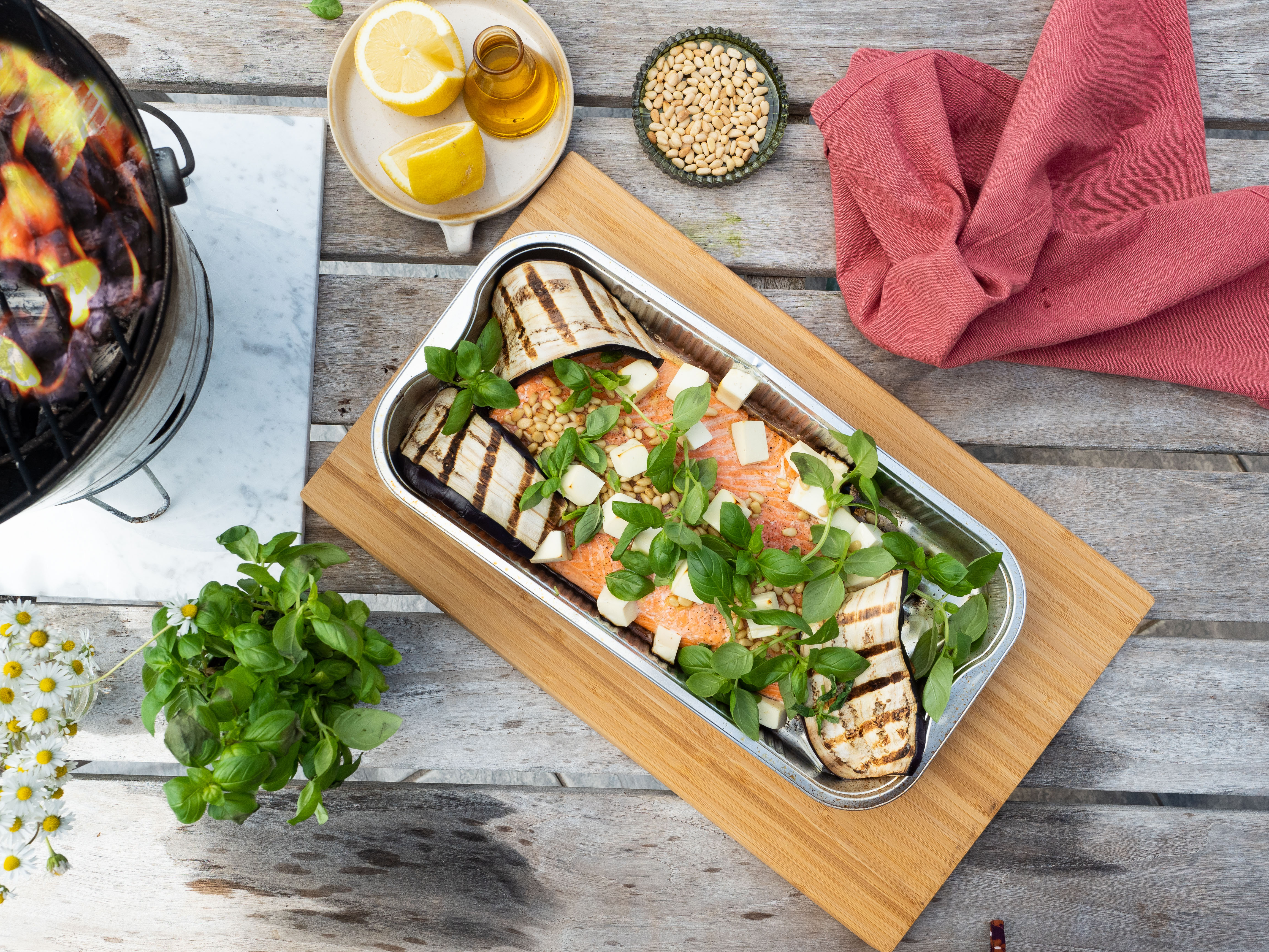 Fried salmon with salad and sesame seeds on a plate placed on a  nicely set table